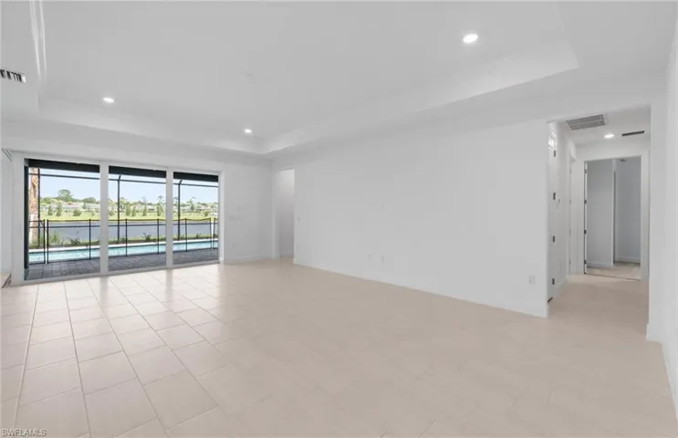 Tiled spare room with a raised ceiling