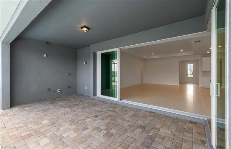 Unfurnished room with light tile patterned floors and a raised ceiling