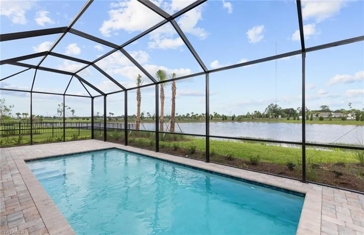 View of swimming pool with a water view, a patio area, and a lanai