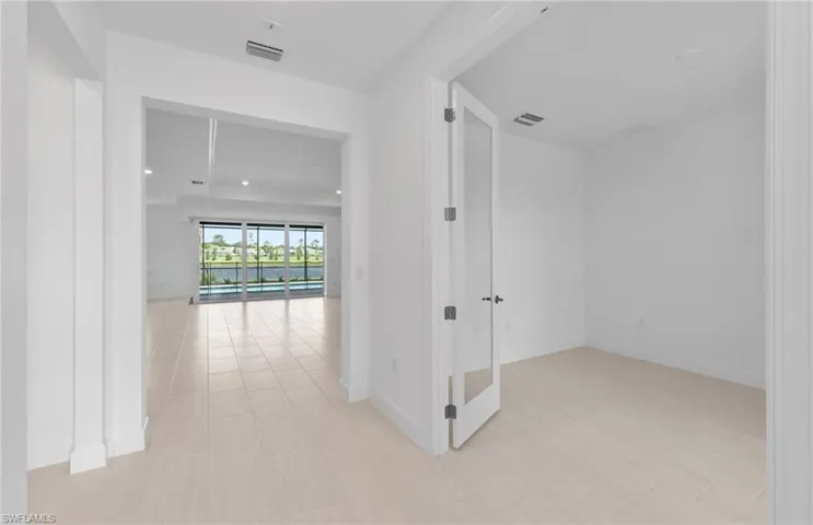 Hall with light tile patterned flooring