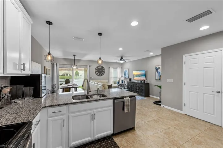 Kitchen with white cabinetry, open floor plan, stainless steel appliances, a peninsula, and recessed lighting