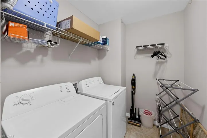 Laundry room with washer and clothes dryer