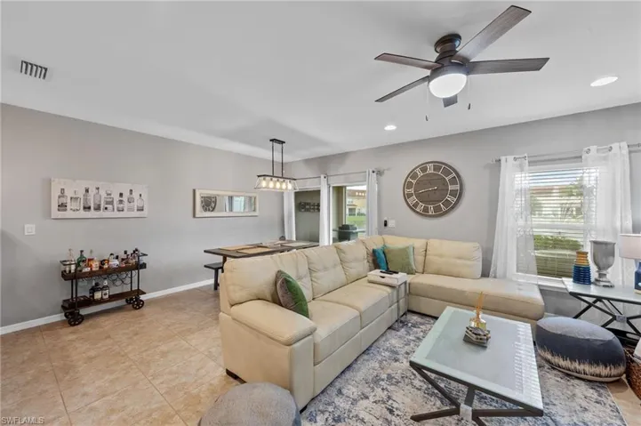 Living room featuring plenty of natural light, tile patterned floors, and recessed lighting