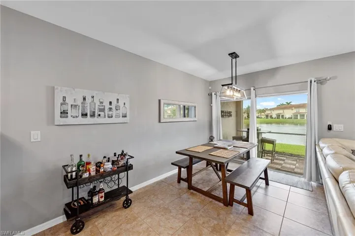 Dining room with a water view and light tile patterned flooring