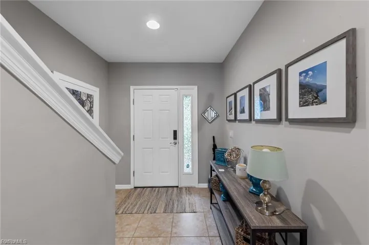 Entrance foyer featuring light tile patterned floors and baseboards