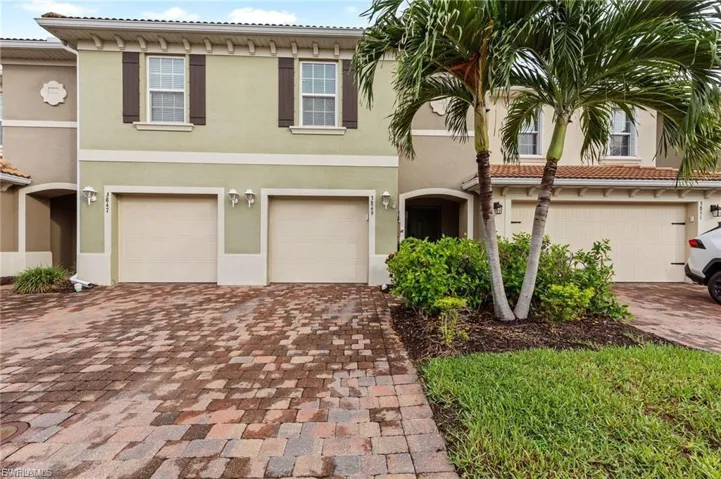 Mediterranean / spanish home with decorative driveway, a garage, and stucco siding