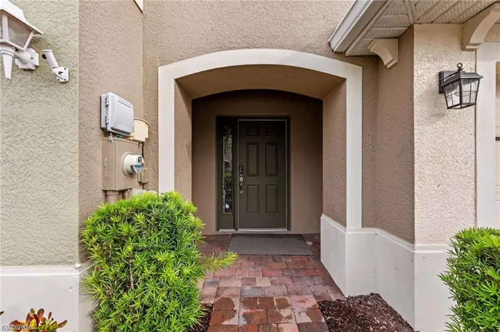 Entrance to property with stucco siding
