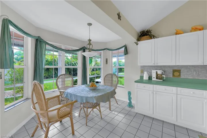 Dining room with lofted ceiling and light tile patterned floors