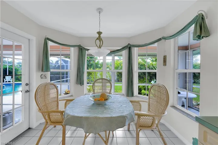 Dining area featuring light tile patterned floors and plenty of natural light