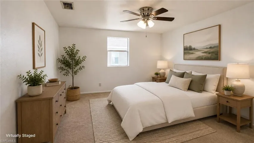 Carpeted bedroom featuring a window with blinds, ceiling fan with light fixture, and neutral wall tones