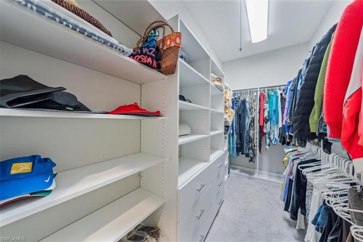 "Her" walk in closet in master bedroom