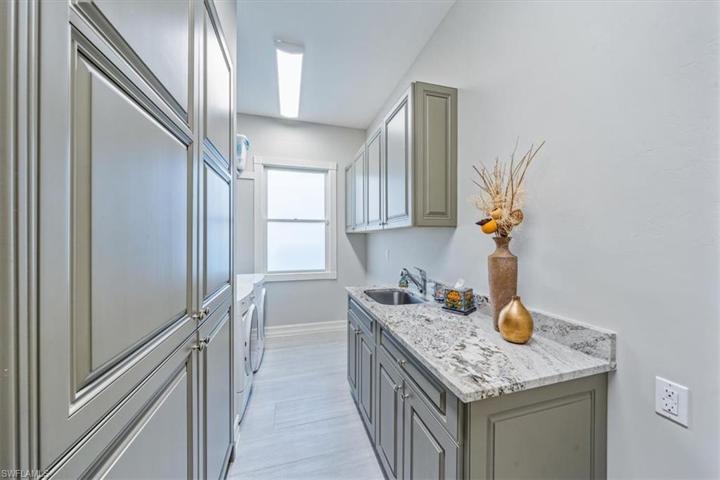 spacious laundry w/ lots of cabinets.