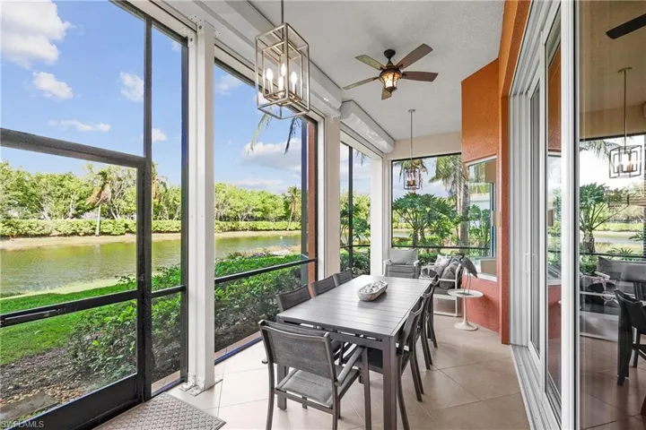 Screened Lanai with electric roll down shutters, ceiling fan a water view, and plenty of natural light