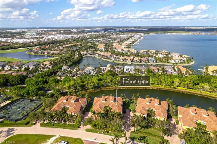 Birds eye view of property with a water view