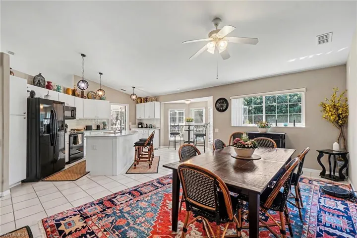 Dining space featuring a ceiling fan and light tile patterned floors