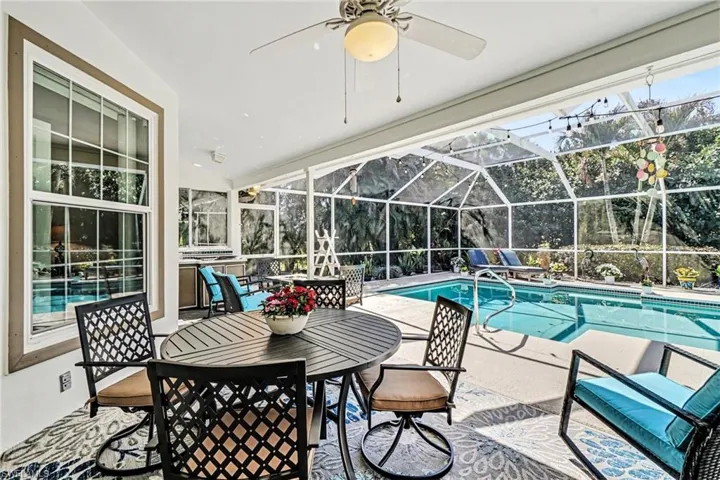 Outdoor pool with a patio area, a sunroom, and a lanai