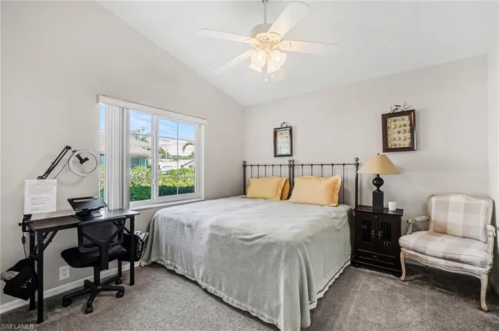 Bedroom featuring carpet, lofted ceiling, and ceiling fan