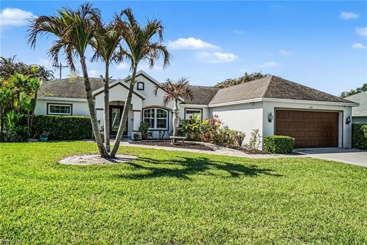 Single story home with a front lawn, a garage, stucco siding, and concrete driveway