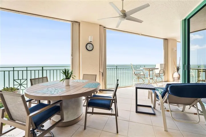 Sunroom featuring a water view and ceiling fan