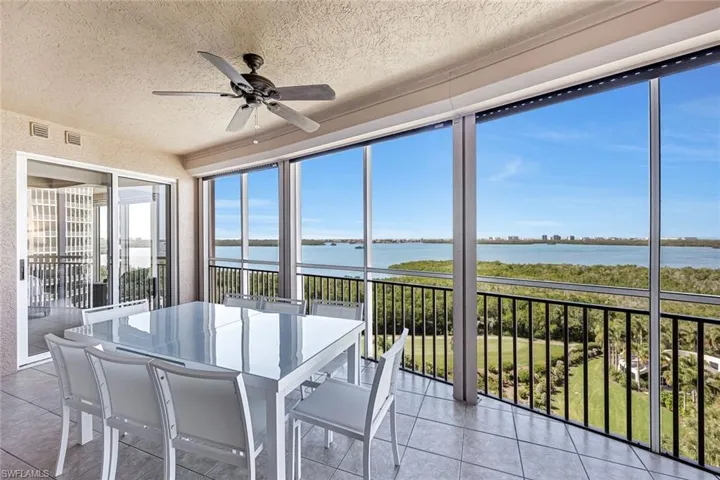 Screened lanai with gorgeous views stretching over the golf course and water.