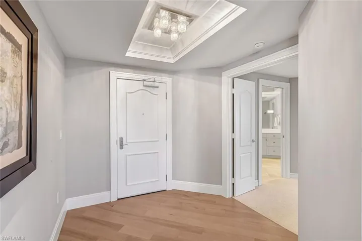 The entry foyer is highlighted by custom lighting and a detailed ceiling treatment.