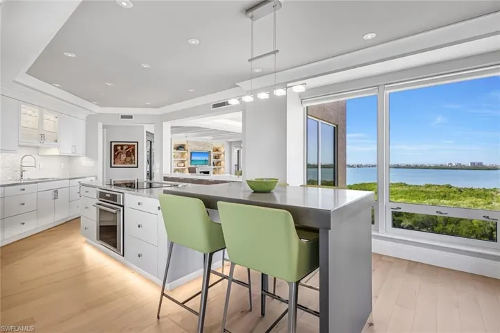 The kitchen island seamlessly extends into an integrated table, perfect for casual dining and entertaining.