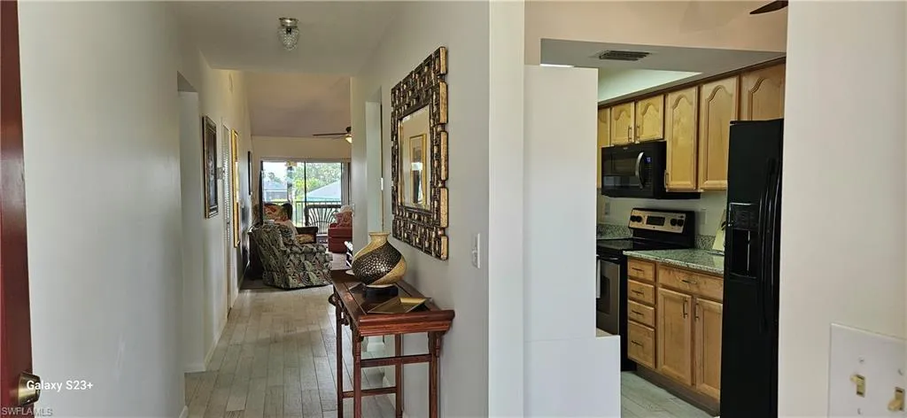 Corridor with light wood-style floors and baseboards