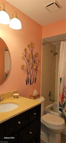 Bathroom featuring vanity and shower / bath combo