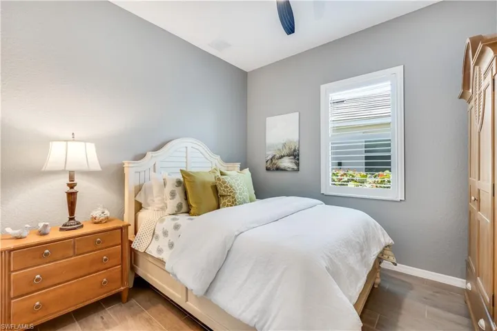 Bedroom with ceiling fan and light hardwood / wood-style flooring