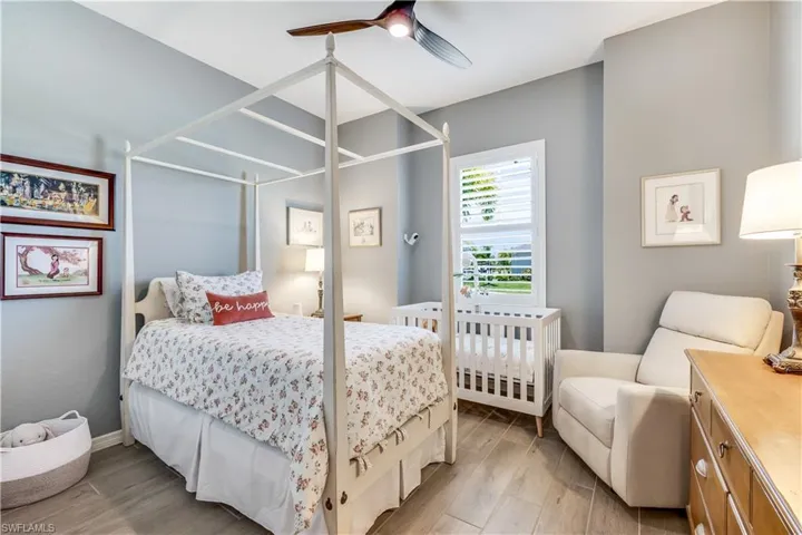 Bedroom with light hardwood / wood-style floors and ceiling fan