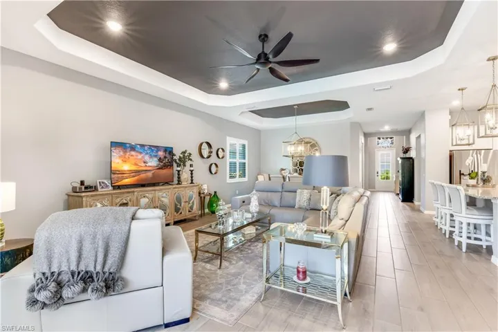 Living room with plenty of natural light and a raised ceiling