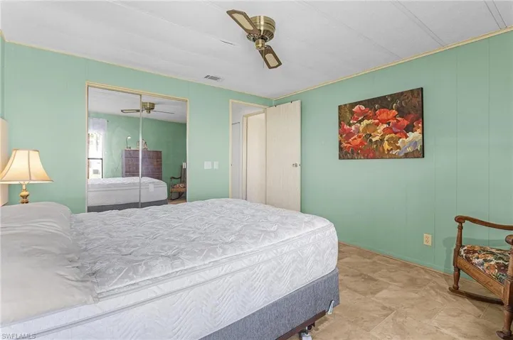 Bedroom featuring visible vents, a closet, and a ceiling fan