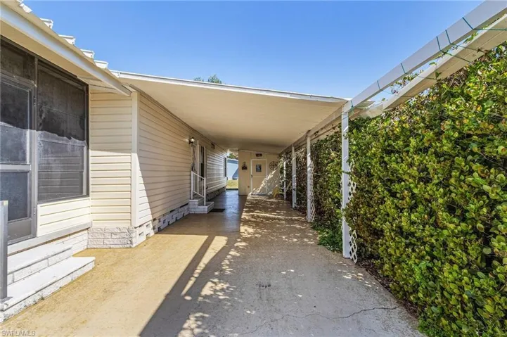 View of patio with an attached carport and driveway