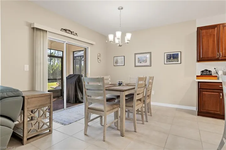Dining space featuring hanging lights and light tile patterned floors