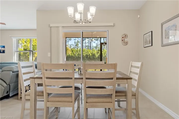 Dining space with a chandelier and light tile patterned flooring