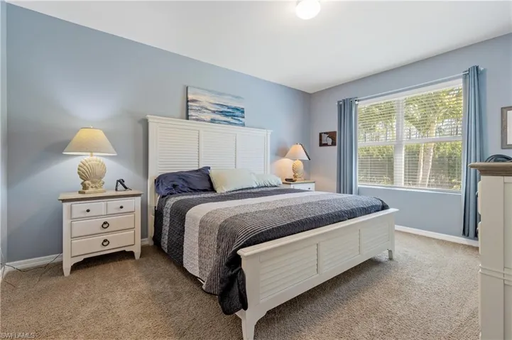 Carpeted bedroom with baseboards