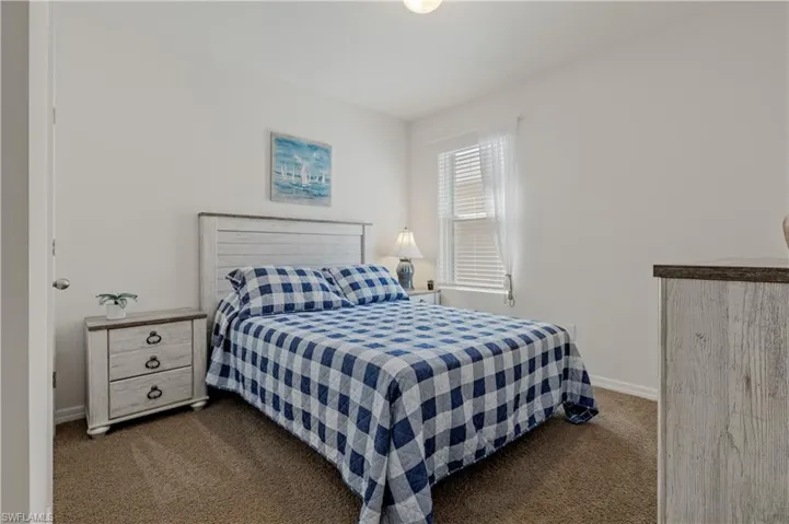 Carpeted bedroom with baseboards