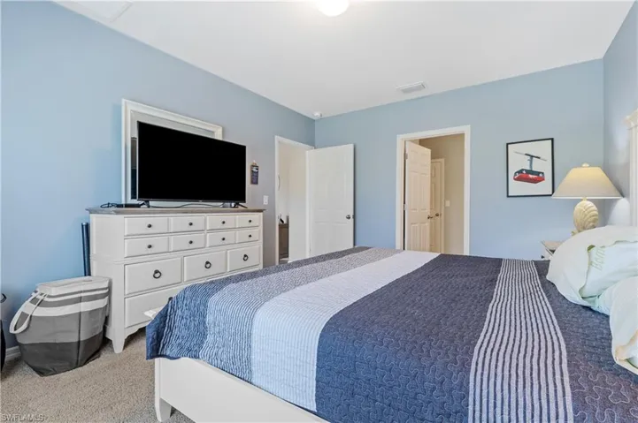 Bedroom with light colored carpet