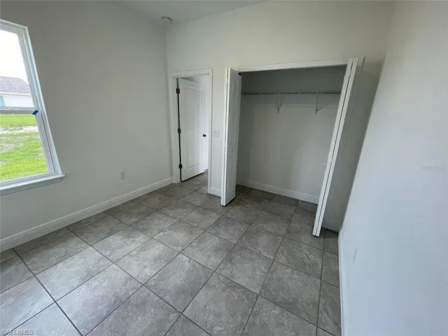 Unfurnished bedroom with a closet