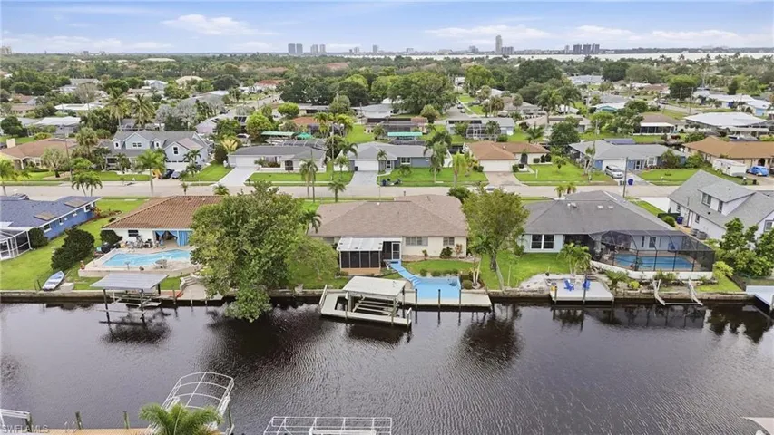 Waterfront properties featuring private boat docks, screened pools, and expansive landscaping