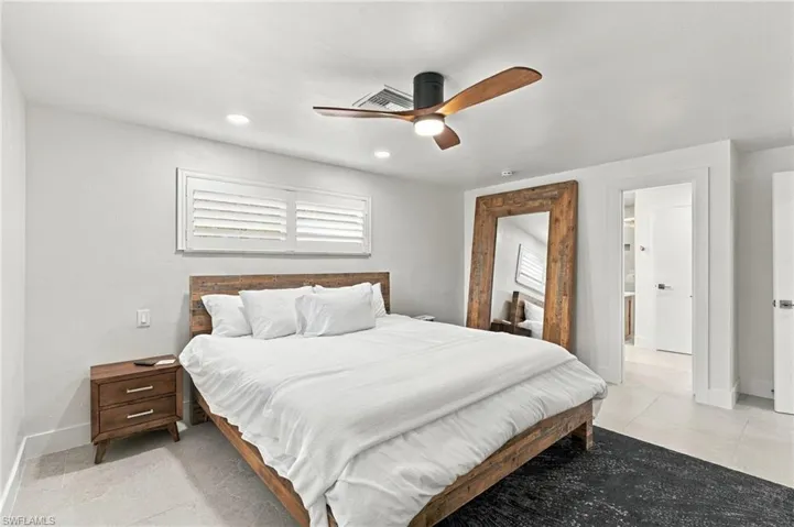 Recessed lighting, ceiling fan with wood-finish blades, white wall finishes, and tile flooring