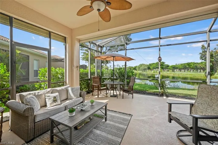 Lanai with a water view and ceiling fan