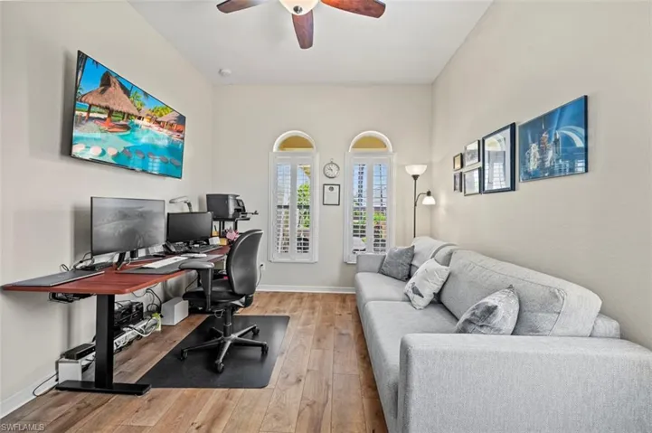 Office space with ceiling fan and light hardwood / wood-style flooring