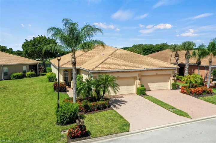 Mediterranean / spanish home with a garage and a front lawn