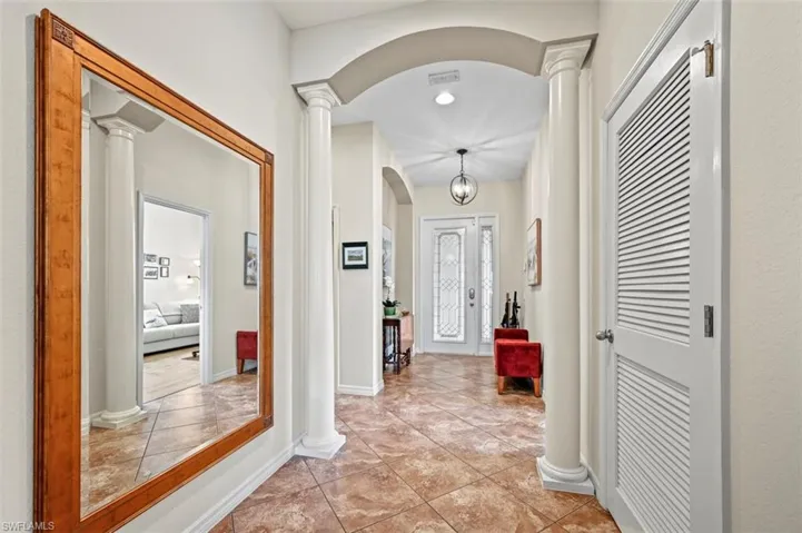 Corridor with ornate columns and tile patterned floors