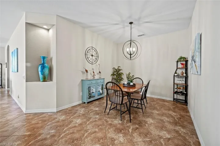 Tiled dining space with a notable chandelier