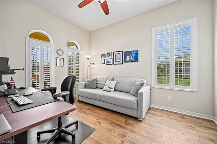 Office area with a wealth of natural light, ceiling fan, and light wood-type flooring