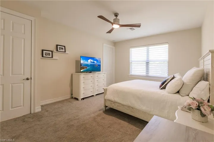 Bedroom featuring ceiling fan and light carpet