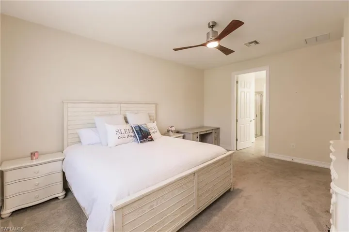 Carpeted bedroom with ceiling fan