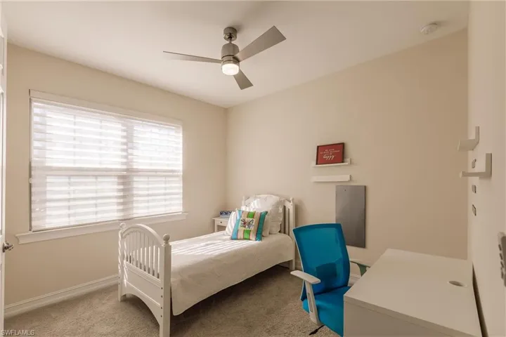 Carpeted bedroom with ceiling fan